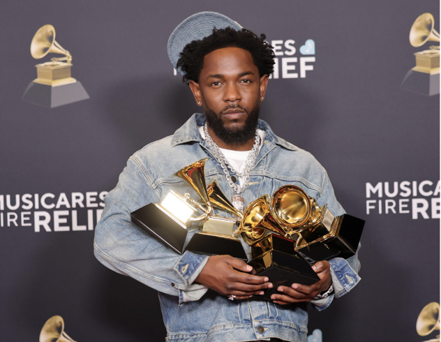 KENDRICK LAMAR HOLDS his collection of Grammys